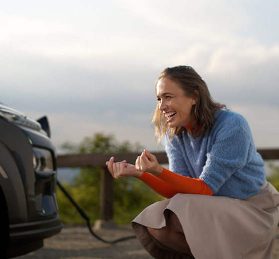 close up of person sitting in front of a car