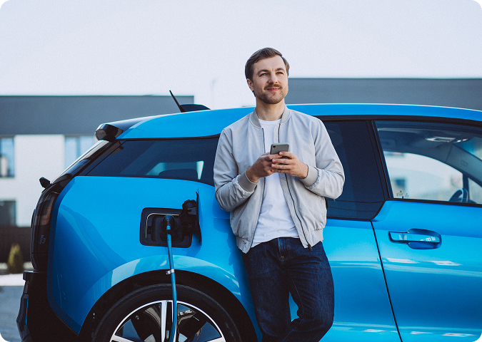 person leaning on a blue charging car