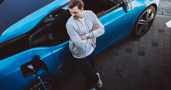 person leaning on a blue car