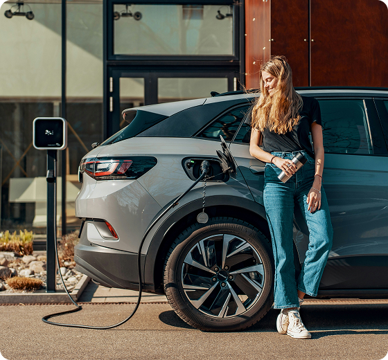 person leaning on a grey charging car