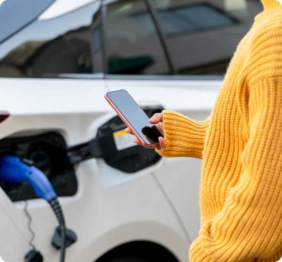 person charging a car using phone
