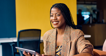 business person using a tablet with orange background