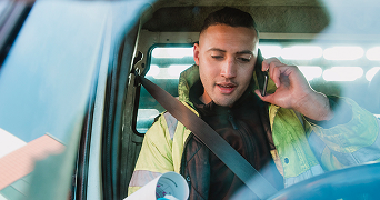 close-up image of person sat in car ,on the phone