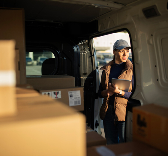 person delivering boxes using van