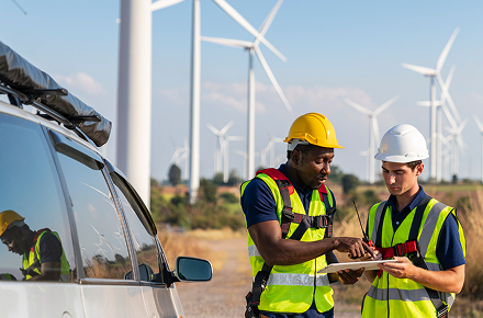 person working in front of wind turbine