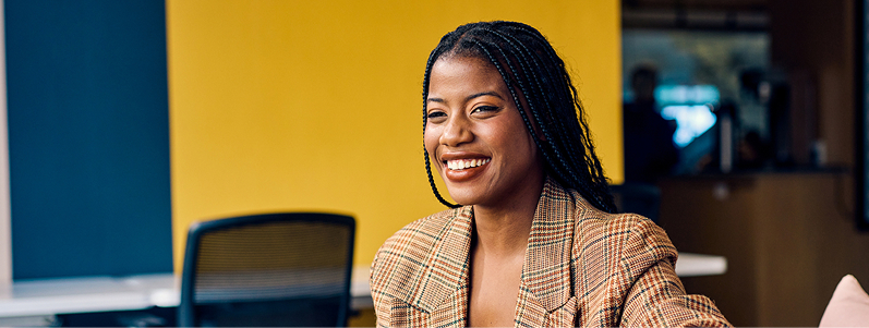 business person using a tablet with orange background